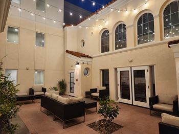 A patio area with a couch, chairs, and a table.